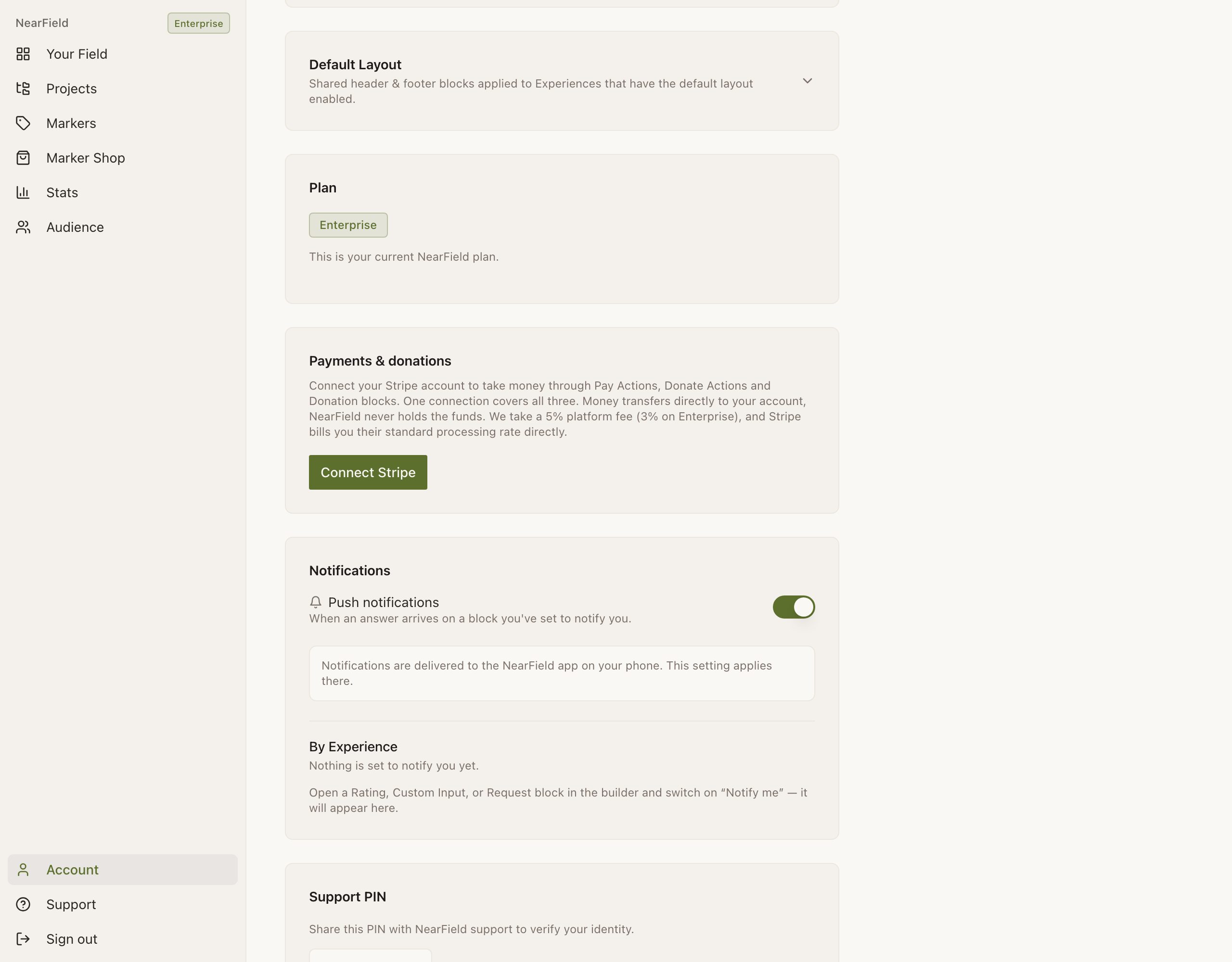 The Account page, scrolled to three cards. **Default Layout**, described as shared header and footer blocks applied to Experiences that have the default layout enabled, with a chevron to expand it. **Plan**, showing an Enterprise badge and the line “This is your current NearField plan.” **Payments & donations**, explaining that one Stripe connection covers Pay Actions, Donate Actions and Donation blocks, that money transfers directly to your account and that NearField takes a 5% platform fee (3% on Enterprise), above a green Connect Stripe button.