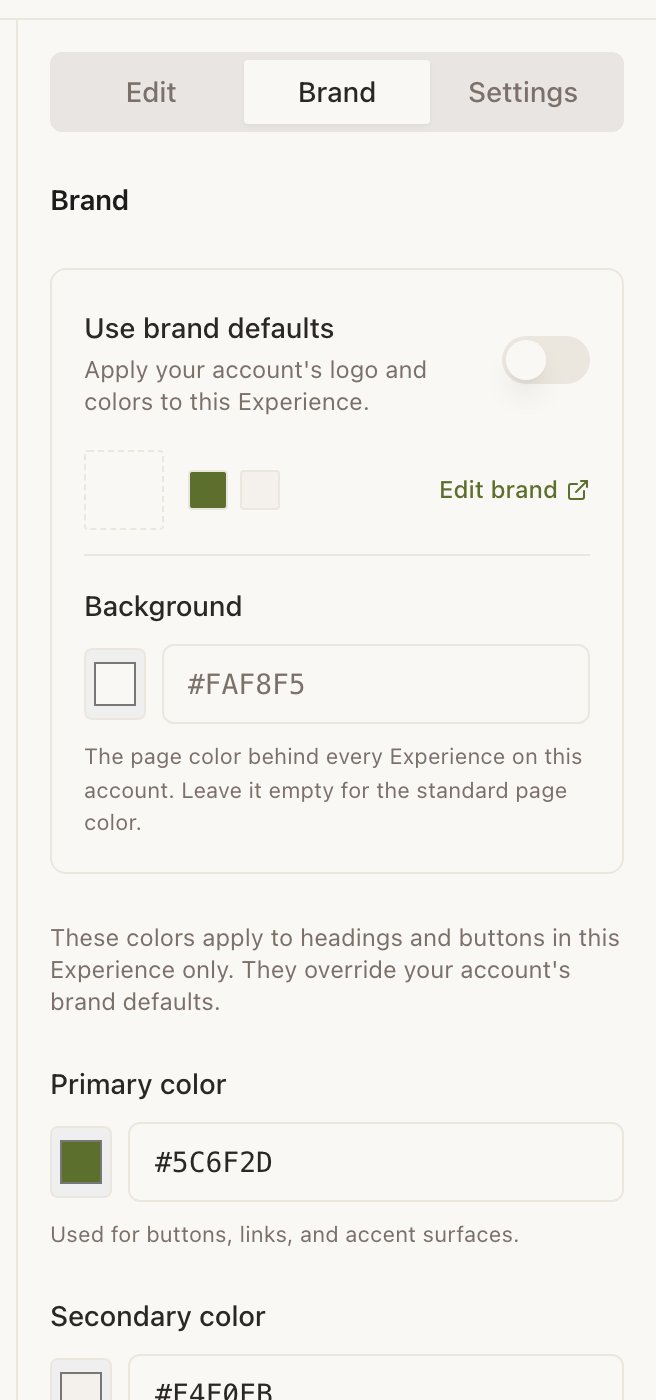 The right rail with the Brand tab selected. A card headed “Use brand defaults” carries a switch in the off position, a row of account swatches, and an Edit brand link out to Account. Under it, Background shows a white swatch beside the field #FAF8F5 with the note that leaving it empty uses the standard page colour. Below the card, a line explains these colours apply to this Experience only and override the account defaults, then Primary color with a dark green swatch and #5C6F2D, and Secondary color with a pale swatch and #F4F0EB.